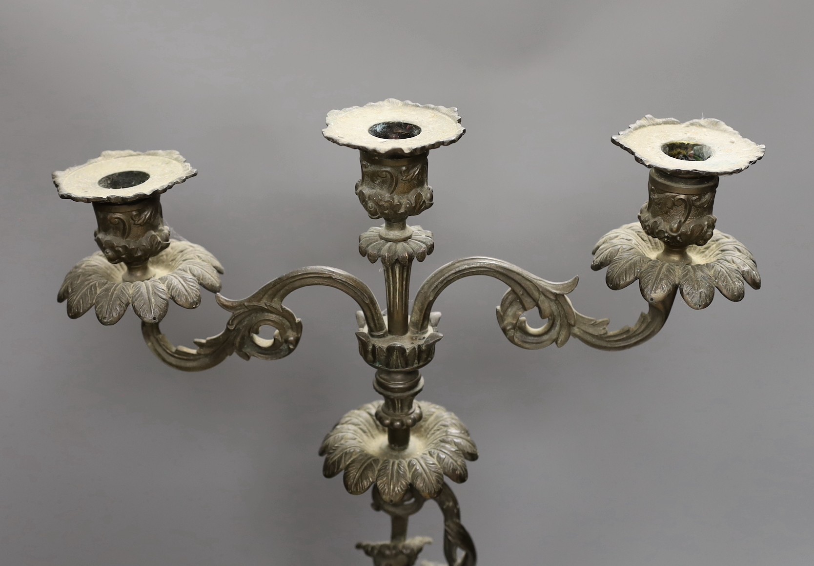 A bronzed spelter figural three light candelabrum, 60cms high